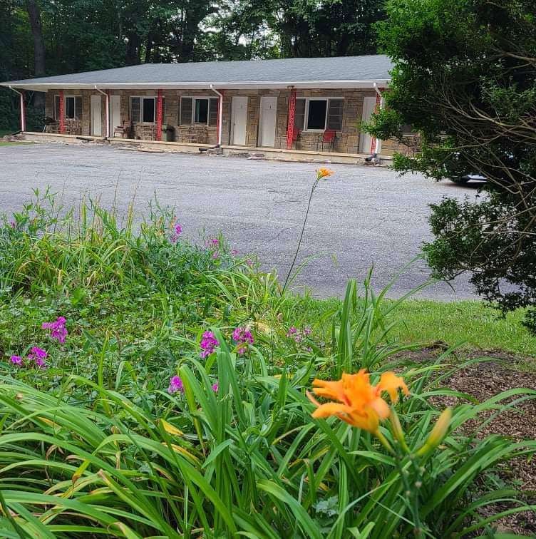 Long motel building with flowers in the foreground