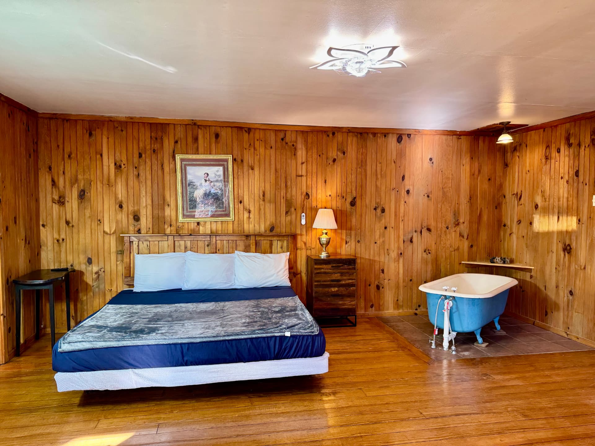 Cabin bedroom with king bed and vintage clawfoot tub