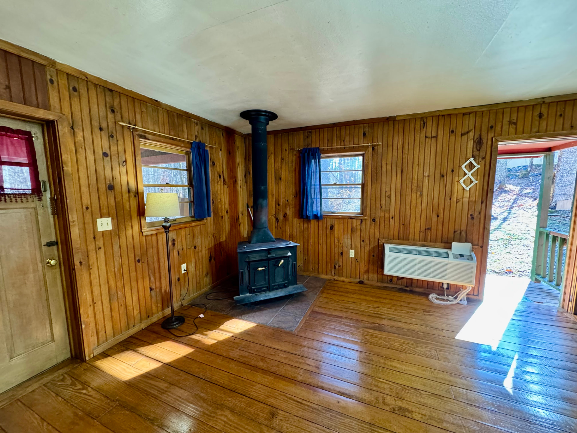 Cabin sitting area with wood stove and heating and air unit